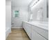 Bright bathroom with white vanity, ample storage, and modern lighting fixtures at 5205 Staughton Dr, Indianapolis, IN 46226