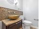 Stylish powder room featuring a vessel sink atop a granite counter with a mosaic tile backsplash at 5205 Staughton Dr, Indianapolis, IN 46226