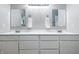 Elegant bathroom featuring double sinks with sleek white cabinetry and matching framed mirrors at 5205 Staughton Dr, Indianapolis, IN 46226