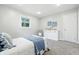 Cozy bedroom featuring a comfortable bed, dresser, and carpeting at 5205 Staughton Dr, Indianapolis, IN 46226
