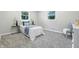 Comfortable bedroom featuring a cozy bed, soft carpet, and natural light from dual windows at 5205 Staughton Dr, Indianapolis, IN 46226