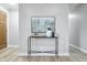 Stylish entryway with modern console table, art, decor and neutral walls and floors at 5205 Staughton Dr, Indianapolis, IN 46226