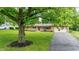 Charming front exterior view with manicured lawn and mature shade tree at 5205 Staughton Dr, Indianapolis, IN 46226