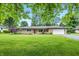 Charming single-story home with an attached garage, well-maintained lawn, and mature landscaping at 5205 Staughton Dr, Indianapolis, IN 46226