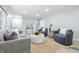 Living room fireplace with neutral paint, contemporary decor, and wood flooring at 5205 Staughton Dr, Indianapolis, IN 46226