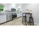 Well-lit kitchen with white cabinets, stainless steel appliances, and modern countertops at 5205 Staughton Dr, Indianapolis, IN 46226