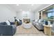 Bright living room featuring neutral paint, wood flooring, a large window, and contemporary furnishings at 5205 Staughton Dr, Indianapolis, IN 46226