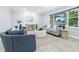 Bright living room featuring neutral paint, wood flooring, a large window, and contemporary furnishings at 5205 Staughton Dr, Indianapolis, IN 46226