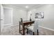 Bright home office featuring a wooden desk, stylish chairs, and neutral decor at 5205 Staughton Dr, Indianapolis, IN 46226