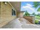 Covered outdoor patio featuring brick architecture, concrete flooring, and views of the surrounding yard at 5205 Staughton Dr, Indianapolis, IN 46226