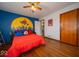 Fun bedroom design with a Spider-Personal mural and hardwood floors, creating a vibrant and playful space at 524 W Campbell St, Edinburgh, IN 46124