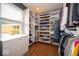 Organized walk-in closet with custom shelving, hardwood floors, and a window offering natural light at 524 W Campbell St, Edinburgh, IN 46124