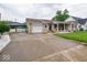 Wide driveway leading to a one-car garage and covered carport at 524 W Campbell St, Edinburgh, IN 46124