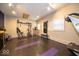 A well-lit exercise room featuring varied workout equipment and black floors with purple accents for a modern touch at 524 W Campbell St, Edinburgh, IN 46124