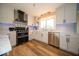 Bright kitchen featuring white cabinets, stainless steel appliances, and hardwood flooring; with modern lighting at 524 W Campbell St, Edinburgh, IN 46124