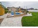 Backyard pool with white rock landscaping, patio furniture, and a basketball court at 524 W Campbell St, Edinburgh, IN 46124