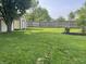 Lush green backyard with a shed, wooden fence, and mature trees around at 5331 Yucatan Dr, Indianapolis, IN 46237
