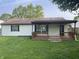 Backyard features a wooden deck, well-kept lawn, and partial fencing at 5331 Yucatan Dr, Indianapolis, IN 46237