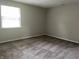 Cozy bedroom with clean, neutral carpet, painted in light grey, and featuring a single window at 5331 Yucatan Dr, Indianapolis, IN 46237