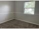 Cozy bedroom with clean, neutral carpet, painted in light grey, and featuring a single window at 5331 Yucatan Dr, Indianapolis, IN 46237
