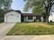 Charming one-story home with a well-kept lawn, attached garage, and an American flag waving at 5331 Yucatan Dr, Indianapolis, IN 46237