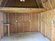 Inside the shed showing plywood walls, electrical outlets, and a workspace ledge at 5331 Yucatan Dr, Indianapolis, IN 46237