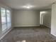 Spacious living room with large window, neutral walls, and soft, clean carpeting at 5331 Yucatan Dr, Indianapolis, IN 46237