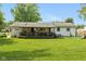 Spacious backyard with a wooden deck and a covered porch, offering an ideal space for entertaining guests at 544 Everling Dr, Morgantown, IN 46160