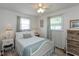 Charming bedroom with neutral walls, a ceiling fan, two windows, and white furniture at 544 Everling Dr, Morgantown, IN 46160