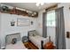 Cozy bedroom featuring two twin beds, a window, hardwood floors, and decorative shelving at 544 Everling Dr, Morgantown, IN 46160