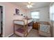 Bedroom featuring a bunk bed, a crib, a ceiling fan, hardwood floors, and pink walls at 544 Everling Dr, Morgantown, IN 46160