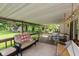 Covered porch with wood furniture, outdoor dining set, porch swing, and ceiling at 544 Everling Dr, Morgantown, IN 46160