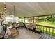 Spacious porch with a lounge area, ceiling fan, porch swing, patio furniture, and ceiling at 544 Everling Dr, Morgantown, IN 46160