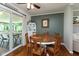 Cozy dining area with a round wooden table, comfortable chairs, and sliding glass doors to the outdoor patio at 544 Everling Dr, Morgantown, IN 46160