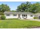 Charming single-story home with a well-manicured lawn and inviting curb appeal with beautiful trees in the background at 544 Everling Dr, Morgantown, IN 46160