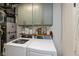 Well-organized laundry room with front load washer and dryer, overhead cabinets, and a shelf at 544 Everling Dr, Morgantown, IN 46160