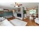 Open-concept living room features a brick fireplace, hardwood floors, and views into the kitchen and dining area at 544 Everling Dr, Morgantown, IN 46160