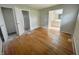 Bedroom with hardwood floors, three entryways, and a view of an adjacent bathroom at 5667 Broyles Rd, Avon, IN 46123