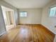 Bedroom featuring hardwood floors, two windows, and a view of the closet at 5667 Broyles Rd, Avon, IN 46123