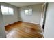 Bright bedroom with hardwood floors, two windows, and ample natural light at 5667 Broyles Rd, Avon, IN 46123