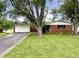 Charming brick home with an attached garage and a well-maintained front yard at 5667 Broyles Rd, Avon, IN 46123