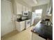 Kitchen with tile countertops and stainless steel sink with an adjacent view of the backyard at 5667 Broyles Rd, Avon, IN 46123