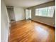 Bright living room featuring hardwood floors, a large window, and a view of the front door at 5667 Broyles Rd, Avon, IN 46123