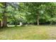 Expansive backyard with mature shade trees and hay bales at 57 E South St, Mooresville, IN 46158