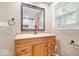 Bathroom boasting a wood vanity, black faucet and hardware, and a framed mirror at 57 E South St, Mooresville, IN 46158