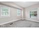 Bedroom features carpeted floors, neutral walls, and plenty of natural light from multiple windows at 57 E South St, Mooresville, IN 46158
