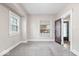 Bright bedroom featuring two windows and neutral-toned walls and carpet at 57 E South St, Mooresville, IN 46158