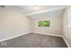 Bedroom with neutral walls, carpet, and a window providing natural light at 57 E South St, Mooresville, IN 46158