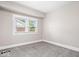 Cozy bedroom with neutral walls and carpet, brightened by natural light from a window at 57 E South St, Mooresville, IN 46158