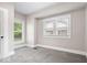 Comfortable bedroom features two windows and soft neutral-colored carpet at 57 E South St, Mooresville, IN 46158